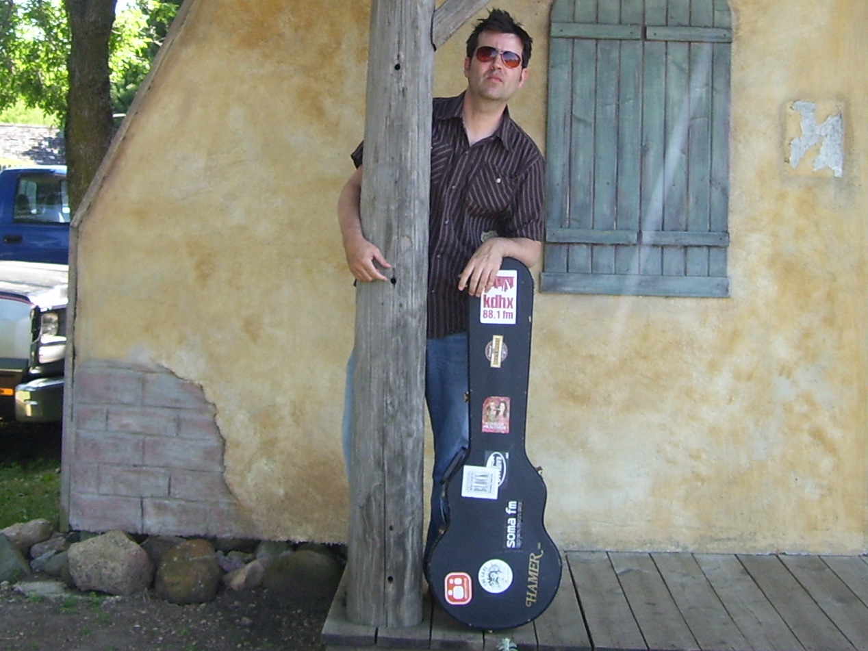 Greg Koons with guitar case